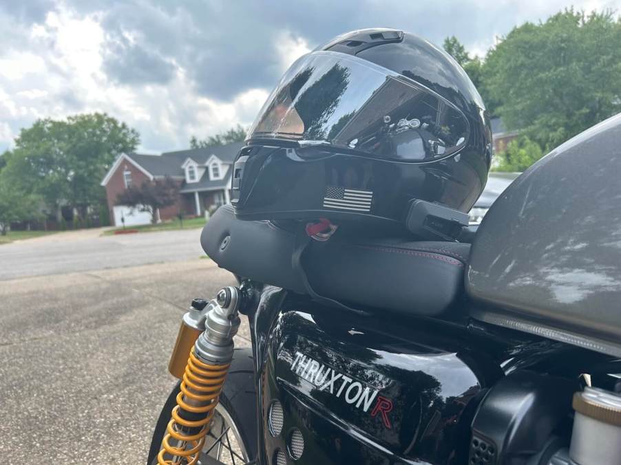 A SHOEI RF-SR motorcycle helmet with a Cardo PACKTALK EDGE Bluetooth unit on a Triumph Thruxton R.