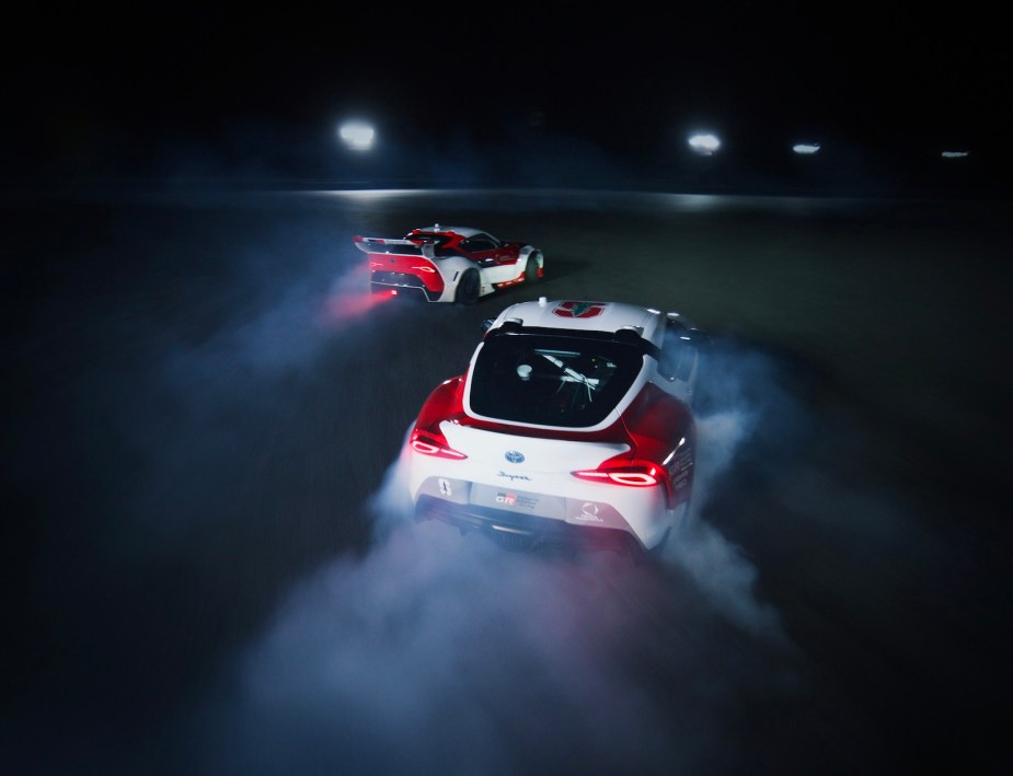 Two autonomous Toyota GR Supras drift around a track.