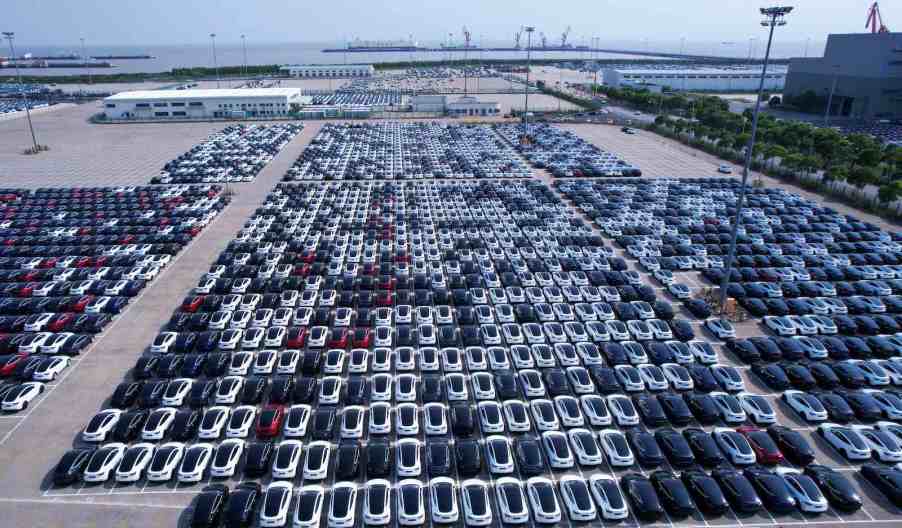 Parking lot full of white Tesla cars