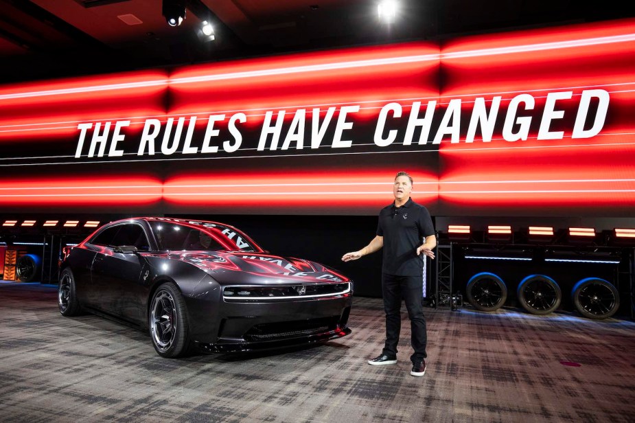 Tim Kuniskis, Dodge CEO, announces its electric Dodge Charger Daytona EV on a stage.