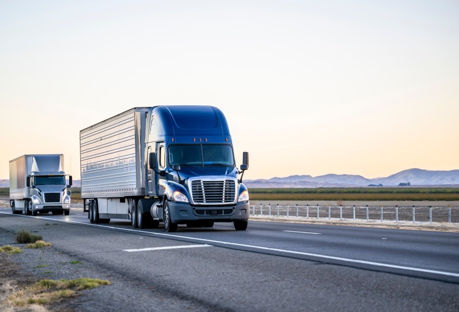 Two semi trucks on the road