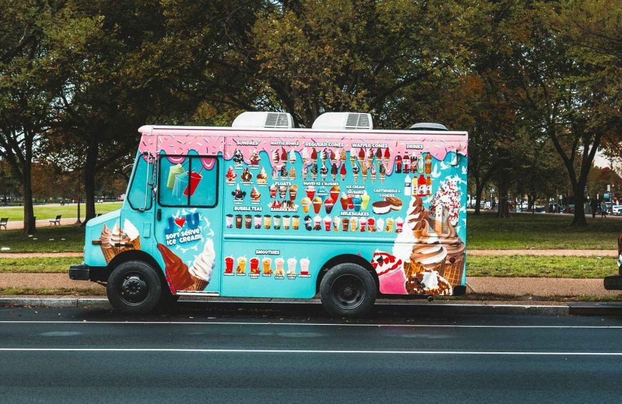 An ice cream truck parked in left profile view