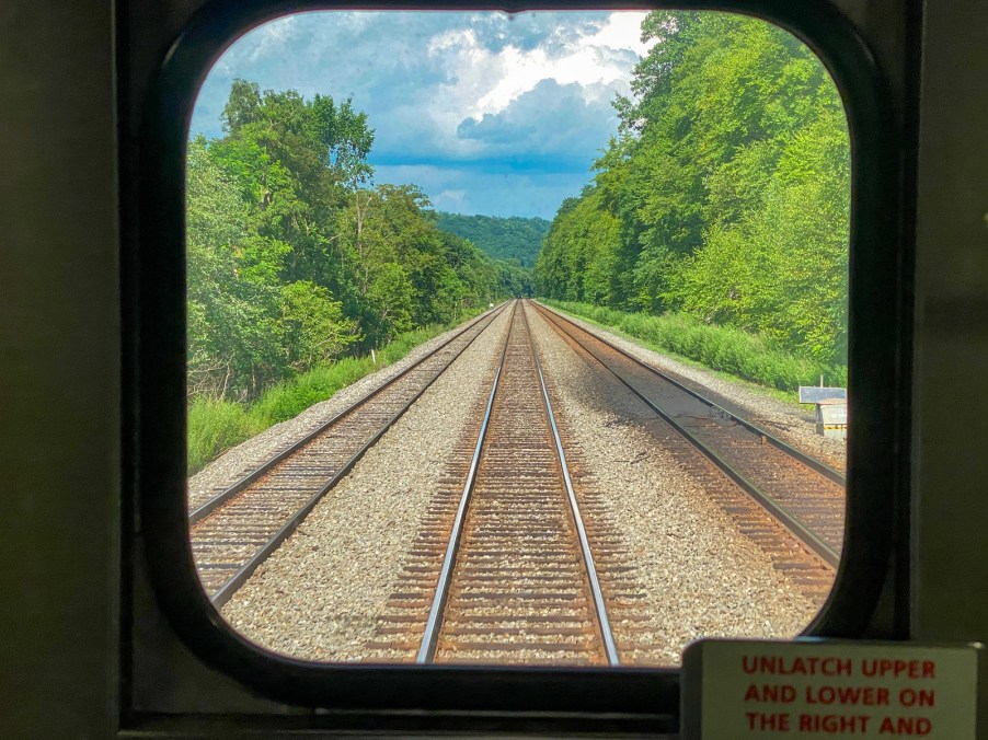 Railroad tracks view from rail car the Great American Rail-Trail is working to convert and connect thousands of miles of pathway across the country