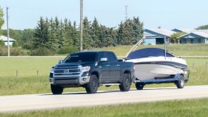 A black Toyota truck towing a boat