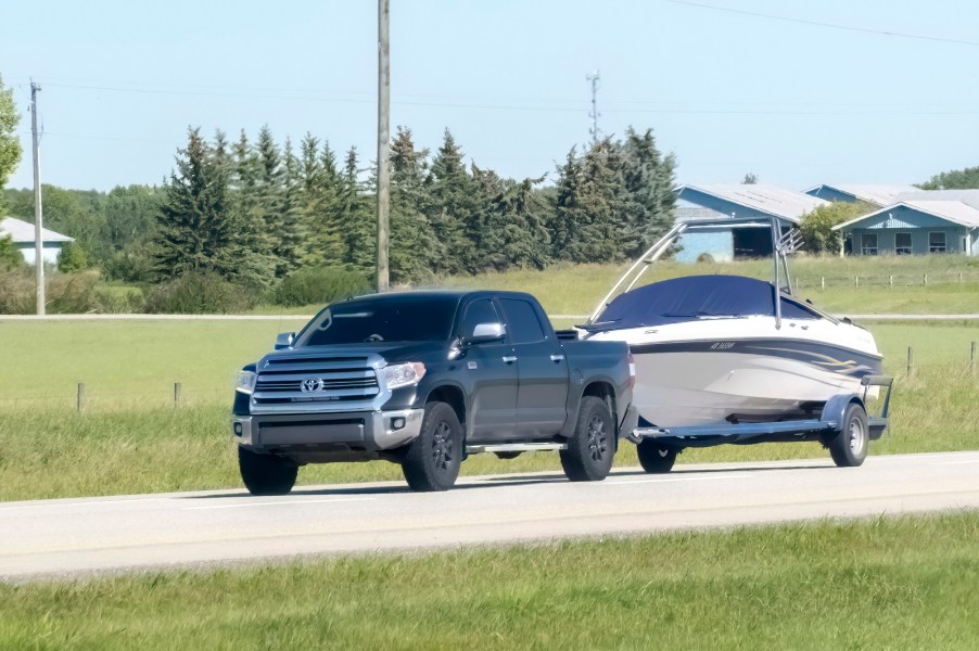 A black Toyota truck towing a boat