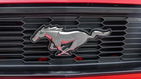 The front grille emblem on a 2012 Ford Mustang GT in very close view