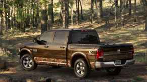 Camouflage Ram 1500 parked in the woods.