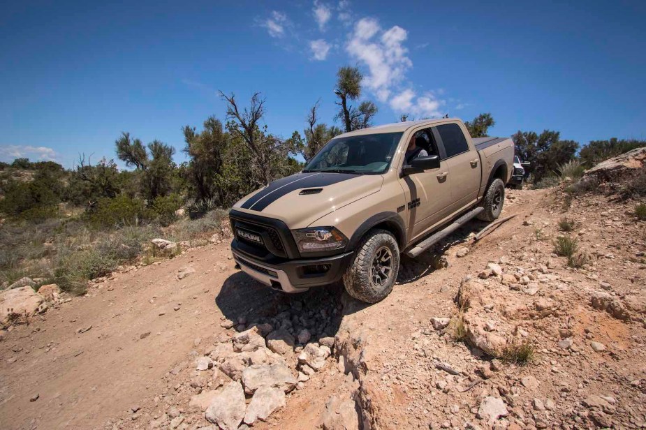 Tan colored Ram 1500 rebel rock crawling.