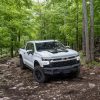 The 2024 Chevrolet Silverado 1500 off-roading in the woods