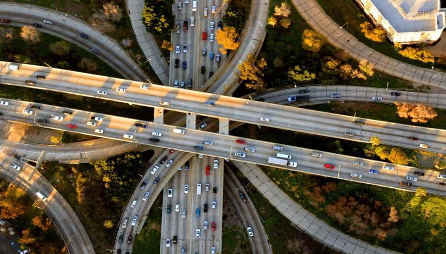 An aerial view of a cars driving on a highway system in the United States.