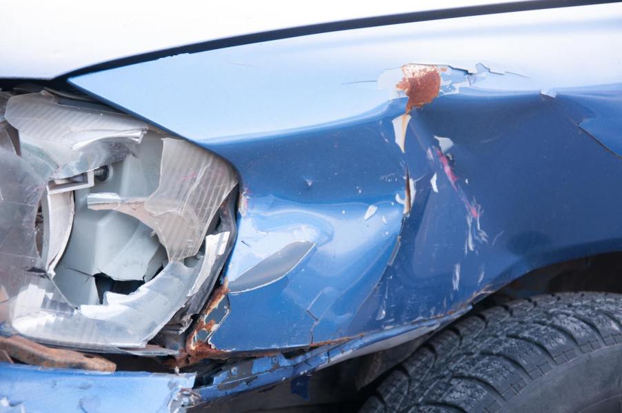 The smashed windshield and fender of a vehicle after a car crash.