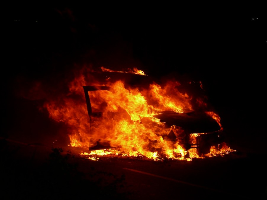 Orange fireball consuming an EV car that's burning