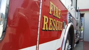 A firetruck shows off its bright red paint at a firehouse.