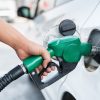 Driver fuels up their luxury car at a gas station.