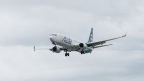 An Alaska Airlines Embraer E175LR with a certified airline pilot approaches a runway.