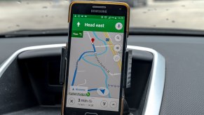 Cellphone on a dashboard running Google Maps navigation