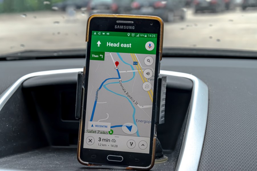 Cellphone on a dashboard running Google Maps navigation