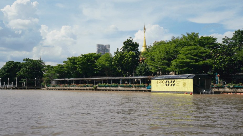 The 'Hippo' barge cleaning trash out of a canal in Bangkok thailand