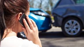 A driver, who pays their car insurance rates, calls their provider after a crash.