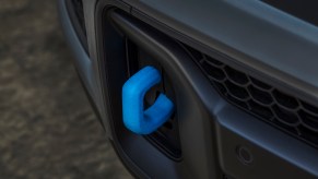 The bright blue tow hooks in the bumper of a plug-in-hybrid Jeep Grand Cherokee