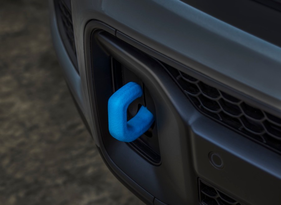 The bright blue tow hooks in the bumper of a plug-in-hybrid Jeep Grand Cherokee