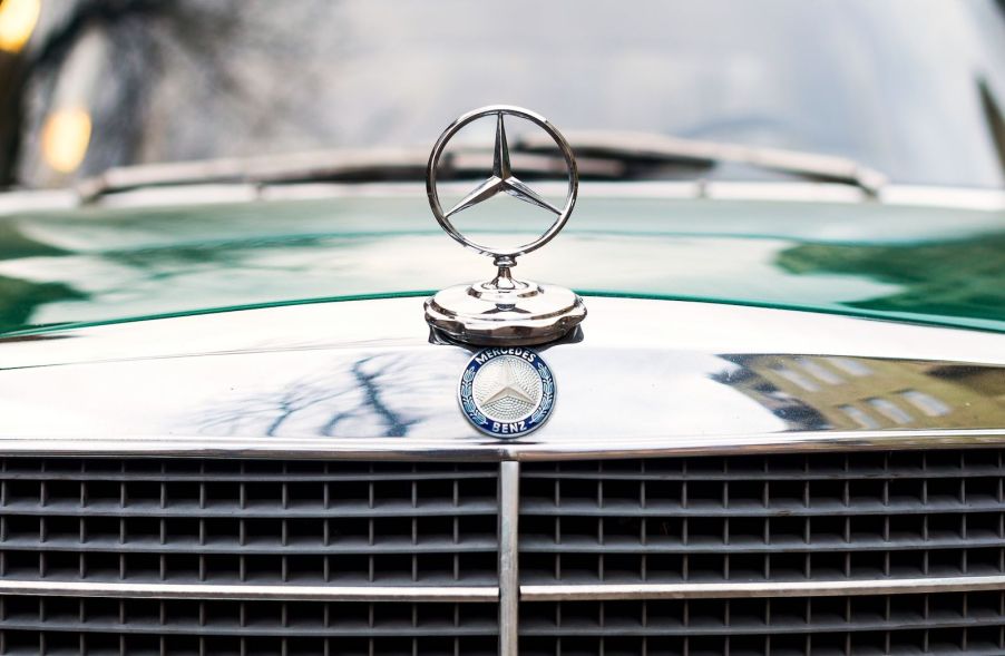 The Mercedes hood emblem on a vintage car.