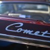 The "Comet" badge on the trunk of a Mercury Comet Caliente at a car show.