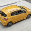 A yellow Mitsubishi Mirage, a natural competitor for the Nissan Versa, shows off its hatchback styling.