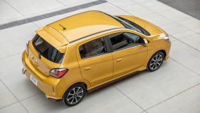 A yellow Mitsubishi Mirage, a natural competitor for the Nissan Versa, shows off its hatchback styling.