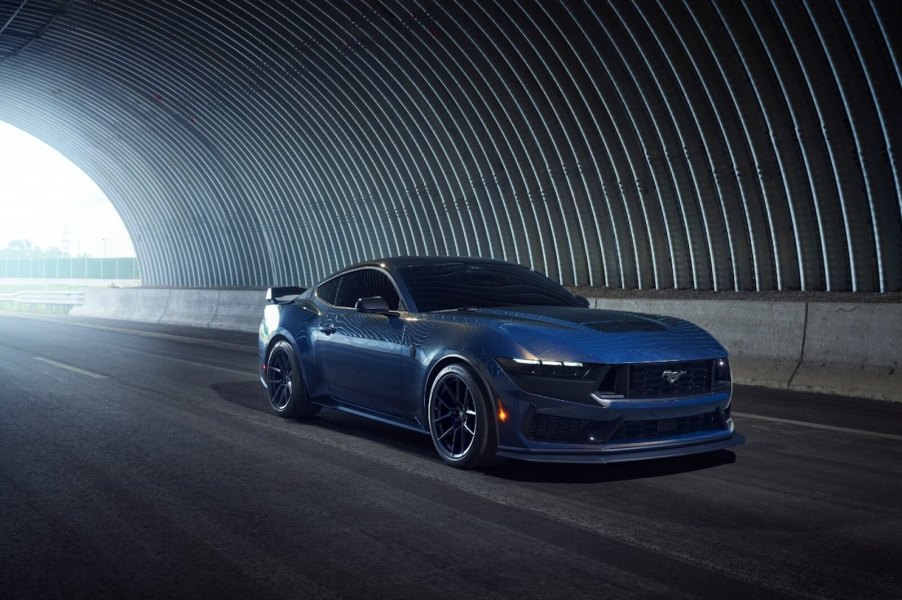 A new Ford Mustang Dark Horse drives through a tunnel.