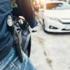 A motorcycle rider hits the road with an open carry handgun on his hip.