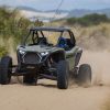 MotorBiscuit Staff Writer Erik Sherman kicks up dust and sand in Coos Bay, Oregon in a Polaris SxS.