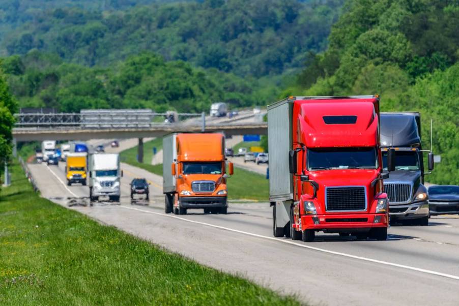 A series of truckers driving semi-trucks on an American highway.