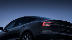 A Tesla Model 3 EV in darkness.