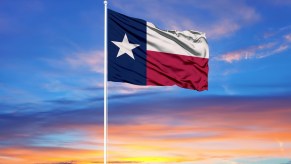 The Texas flag in front of a setting sun