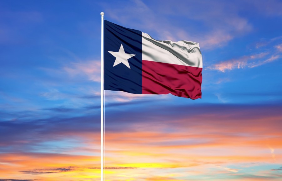 The Texas flag in front of a setting sun