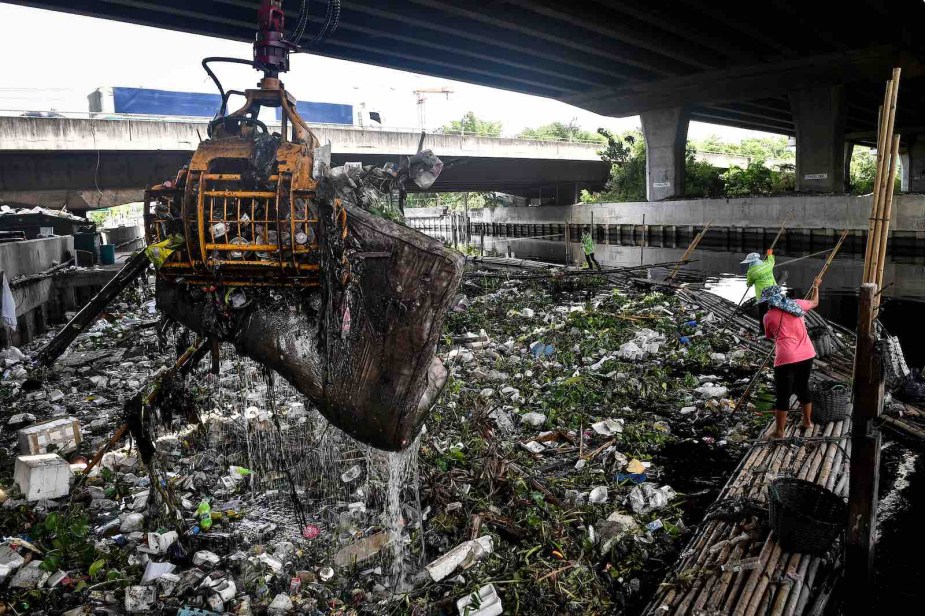 Thai workers clear trash from Bangkok canals.