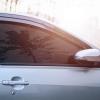 A car shows off its windows and its level of tint darkness.