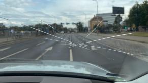 A car windshield requires repair after a crack spreads.