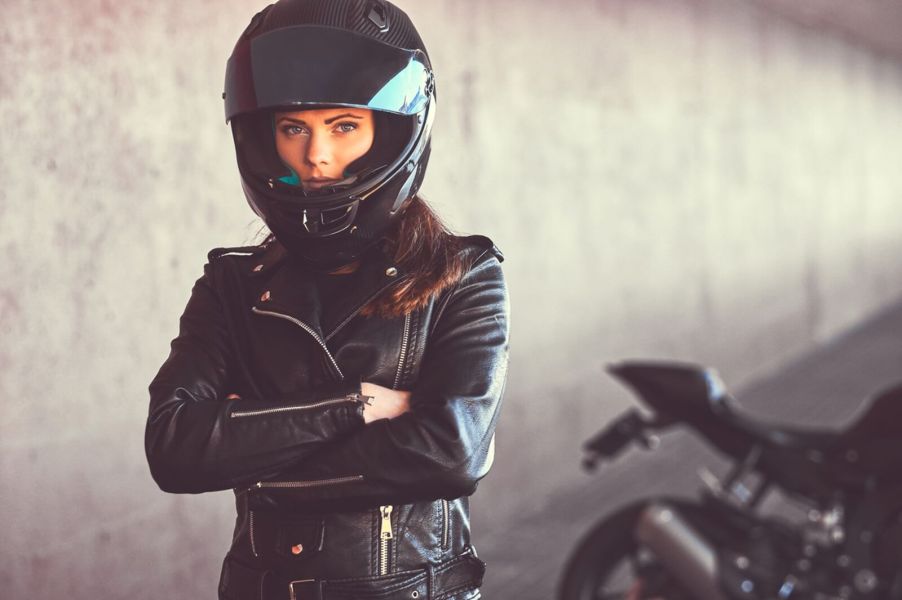 A disappointed motorcycle rider with arms folded, likely after being followed by a tow truck.