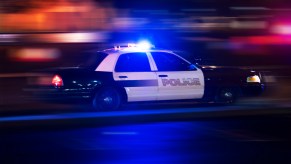 A police squad car racing with its lights on