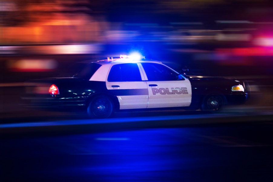 A police squad car racing with its lights on