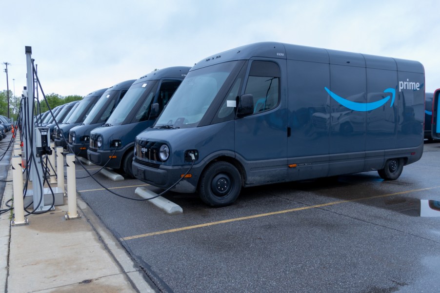 A fleet of Amazon Electric Deliver Vans charging