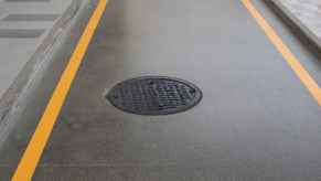 A manhole cover in a paved road