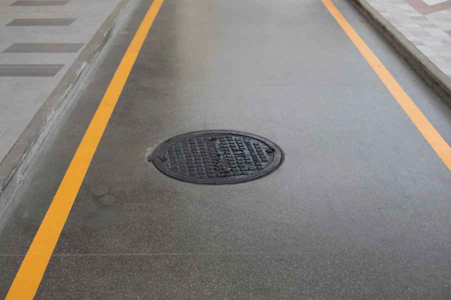 A manhole cover in a paved road