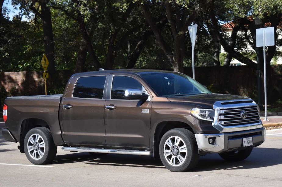 Brown Toyota Tundra in texas, trees visible in the background.