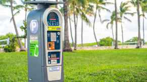 A ParkMobile parking meter in front of palm trees some ParkMobile meters are being targeted by a parking scam in 2024