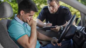 Driver hangs his head while police question him