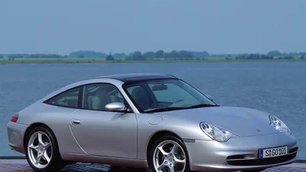 A silver 996 Porsche 911 shows off its styling.