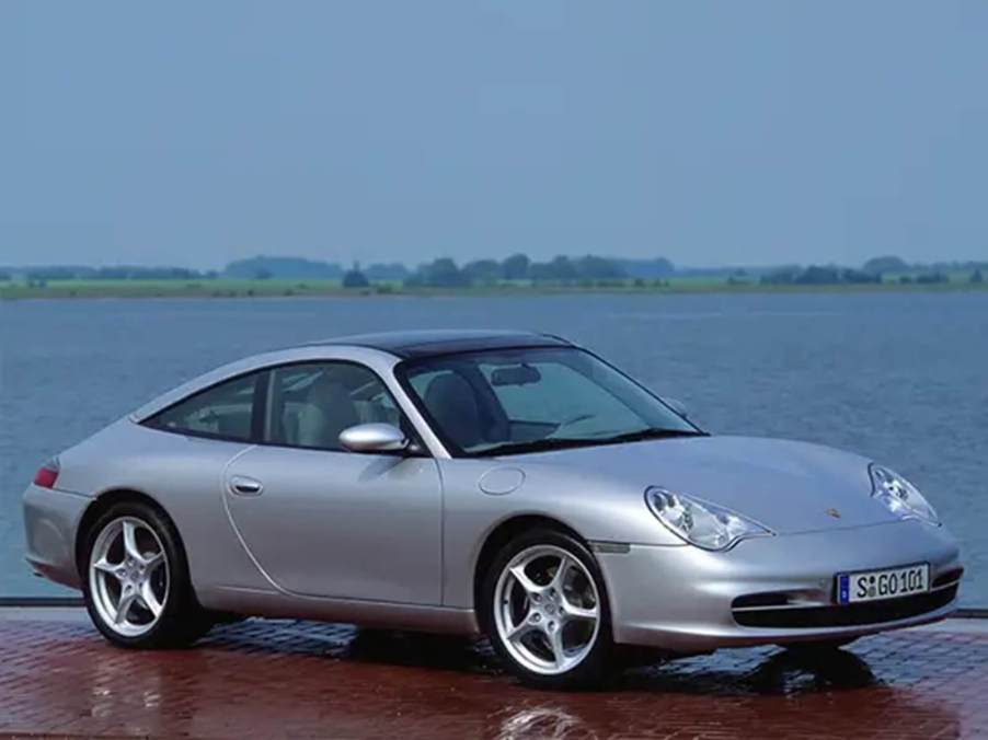 A silver 996 Porsche 911 shows off its styling.